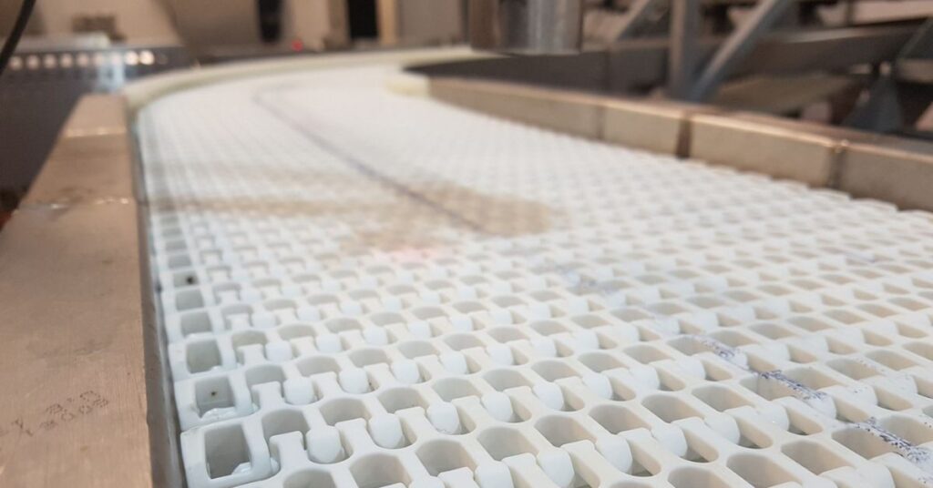 Esteira modular plástica usada em indústria alimentícia.